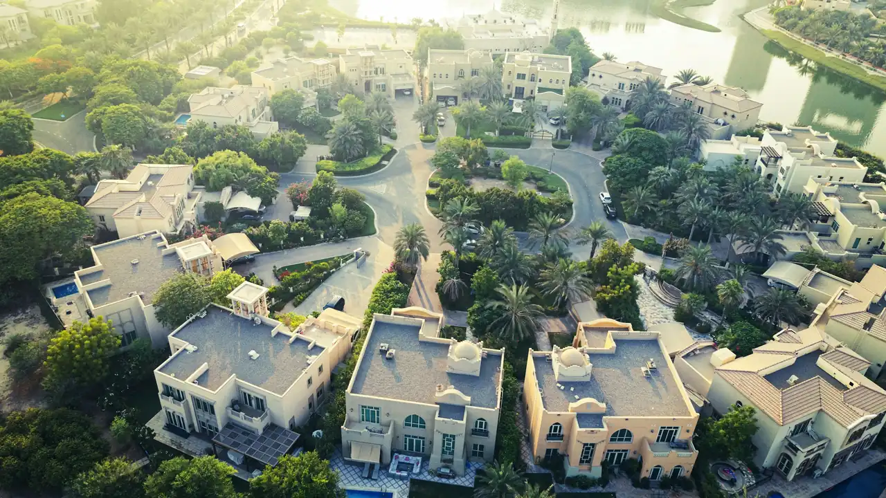A villa community with pools and greenery seen from above