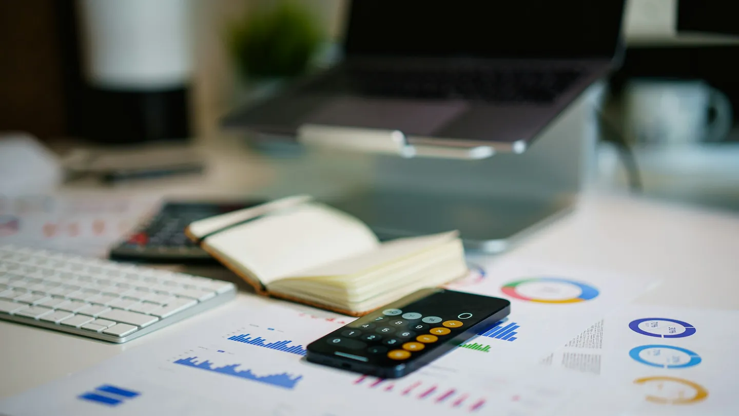 Desk with financial reports and a calculator