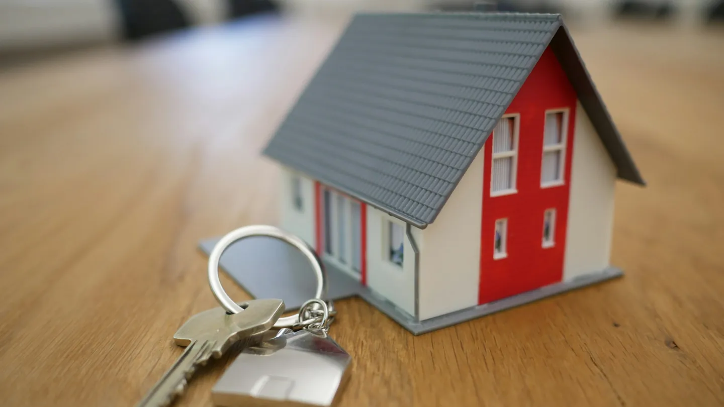 Model house and keys on a table