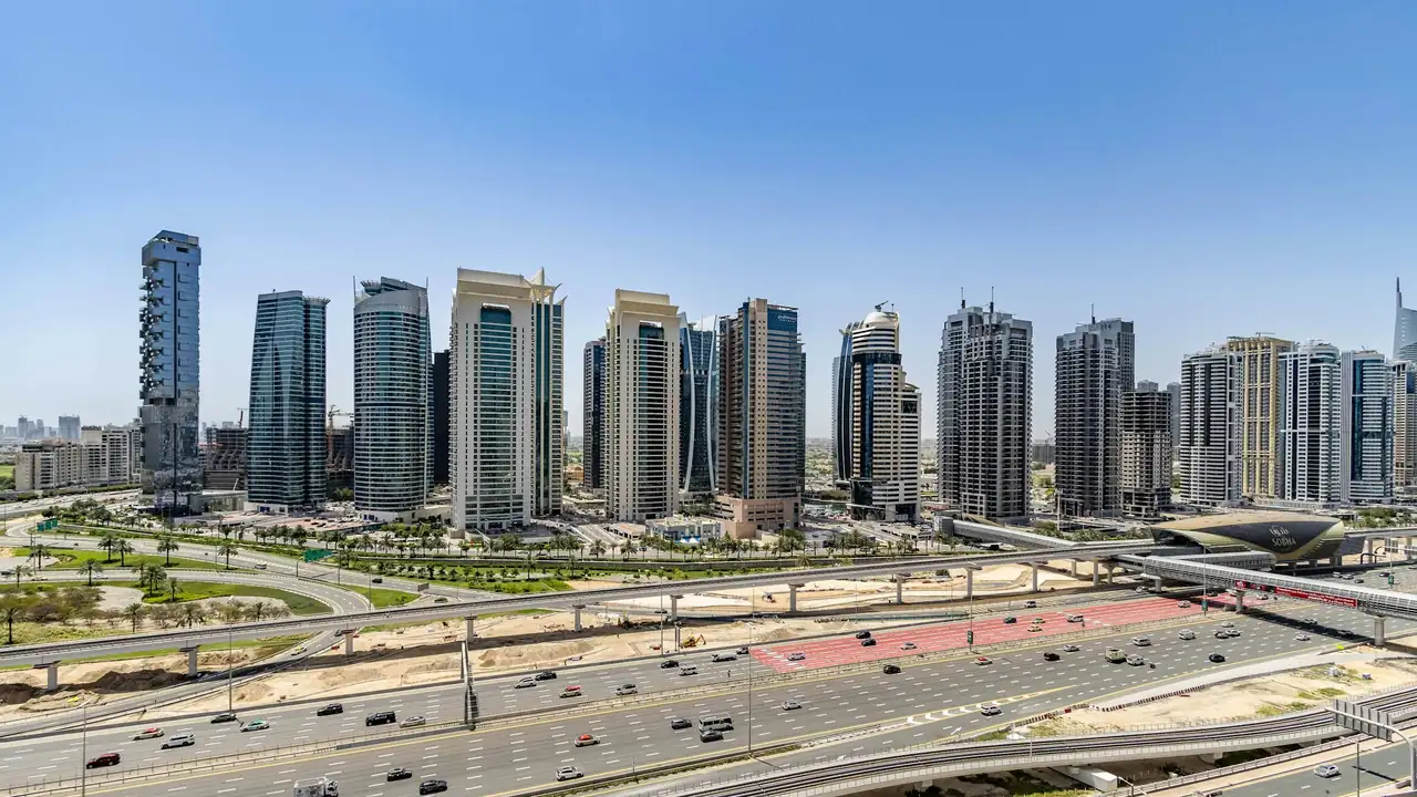 A row of residential and office towers along a Dubai highway