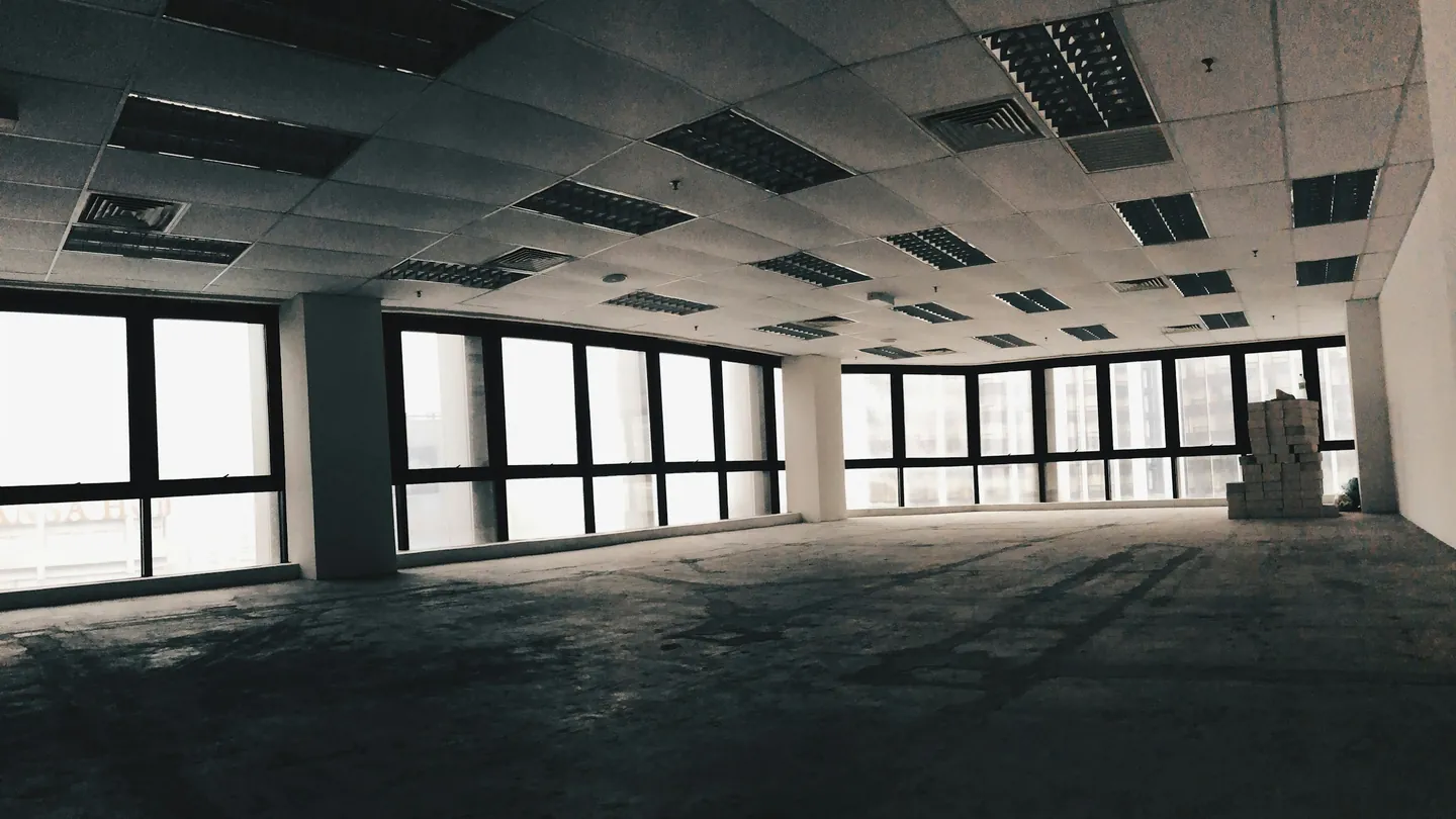 An empty office floor with windows all around