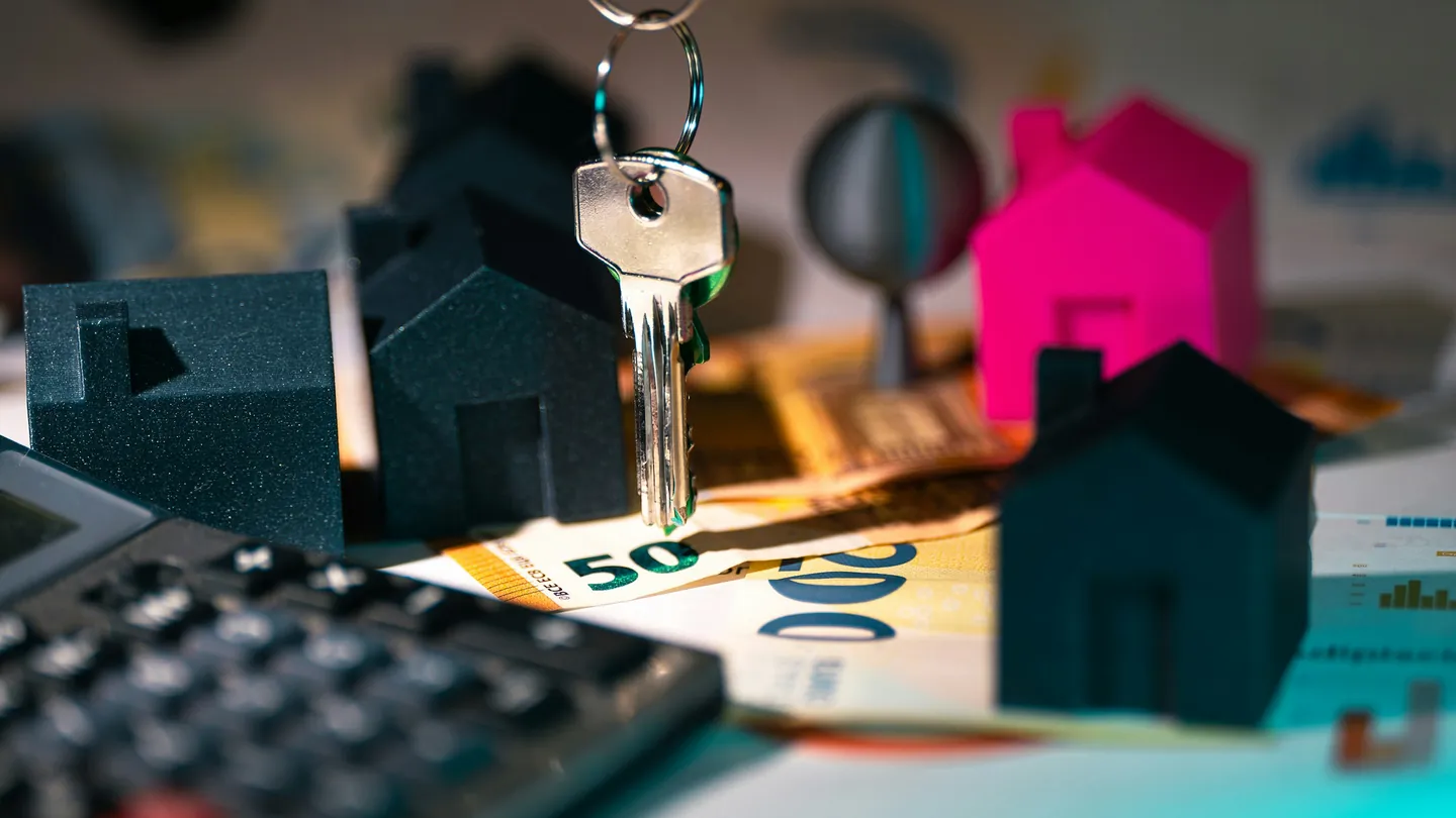 Calculator, keys and model houses