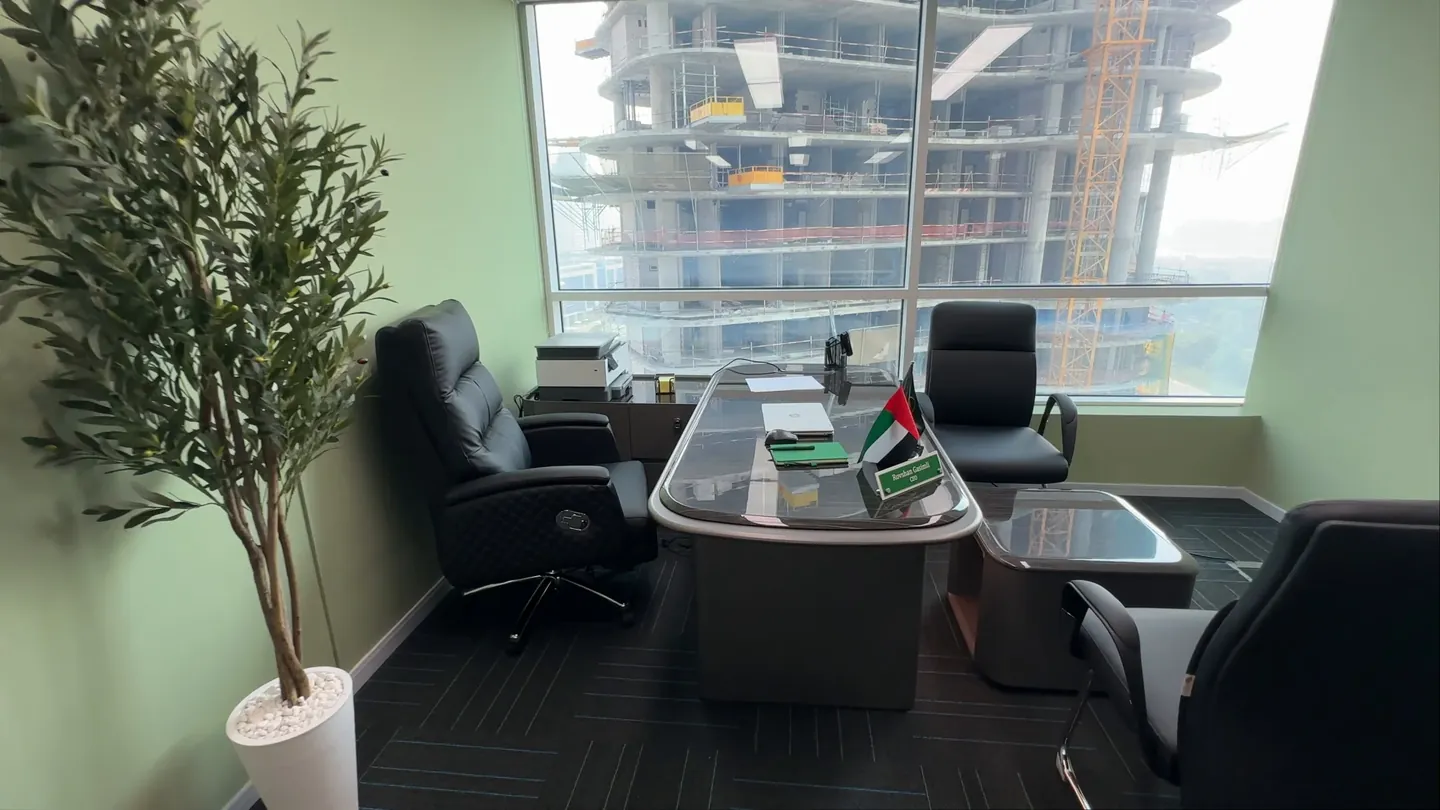 A lawyer’s desk with small UAE flags by the window